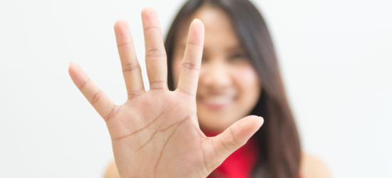 Business woman holding up five fingers.
