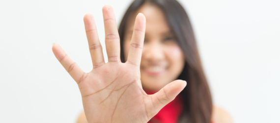Business woman holding up five fingers.