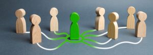 The green figure of a person unites other people around him. Concept of Managed IT support to team.